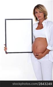 Pregnant women holding picture frame
