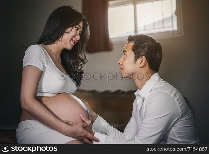 Pregnant women with her husband feeling happy