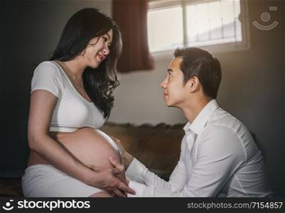 Pregnant women with her husband feeling happy