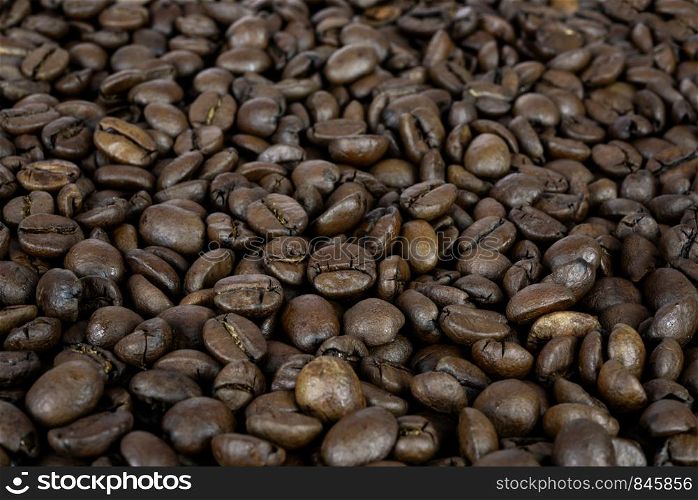 Premium coffee background - many roasted brown beans in close-up as a texture (high details).