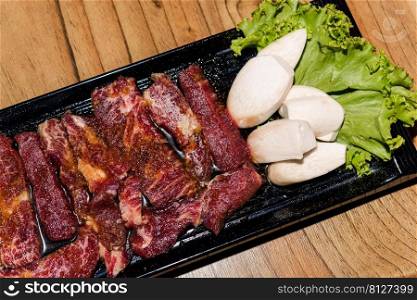 Premium frozen raw pork on plate, Korean traditional style fresh pork beef belly BBQ, Japanese meat hot pot or Shabu in the restaurant, barbecue food