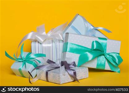 preparation for the holiday - a group of gifts on a yellow background. Birthday