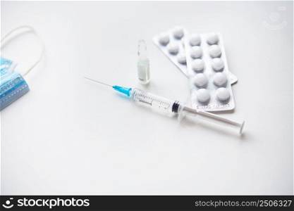 Preparation for vaccination against covid-19. Syringe, vaccine, pills, medical mask. Preparation for vaccination against covid-19. Syringe, vaccine, pills, medical mask.