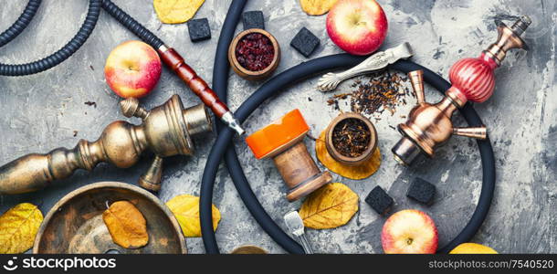 Preparation of a smoking hookah.Oriental hookah with a fruit aroma.Hookah on an apple.. Turkish smoking hookah