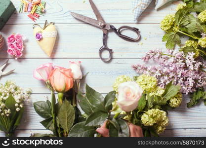 Preparation of flower bouquet, top view of florist workplace with copy space