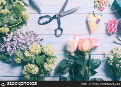 Preparation of flower bouquet, top view of florist workplace with copy space
