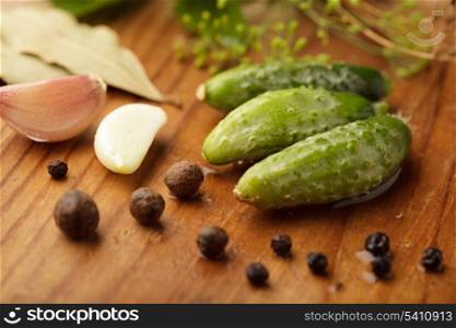 Preparation of small cucumber preserving on wooden table
