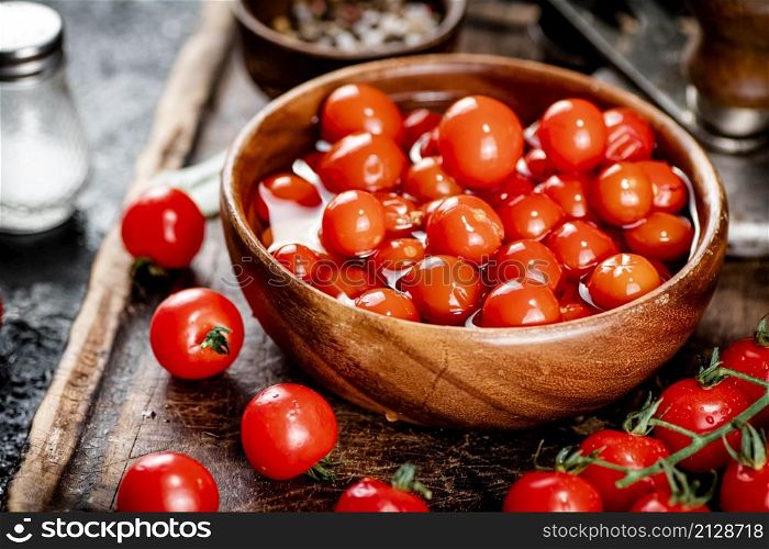 Preparation of tomatoes for pickling on a cutting board. On a black background. High quality photo. Preparation of tomatoes for pickling on a cutting board.