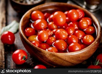 Preparation of tomatoes for pickling on a cutting board. On a black background. High quality photo. Preparation of tomatoes for pickling on a cutting board.