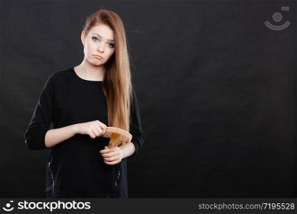 Preparation to evening party. Gorgeous attractive woman combing her long straight smoothy healthy hair before go out. Party and celebration concept.. Long haired girl combing her beauty hair.
