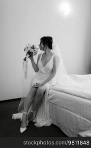 preparations for the bride with the dressing of the wedding dress in the studio