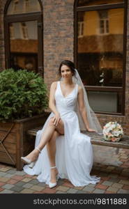 preparations for the bride with the dressing of the wedding dress in the studio