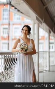 preparations for the bride with the dressing of the wedding dress in the studio