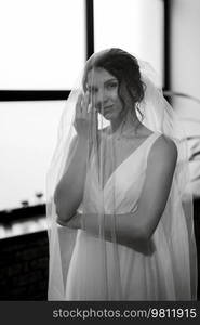 preparations for the bride with the dressing of the wedding dress in the studio