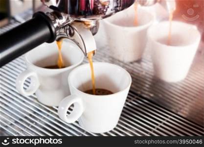 Prepares espresso in coffee shop with vintage filter style, stock photo