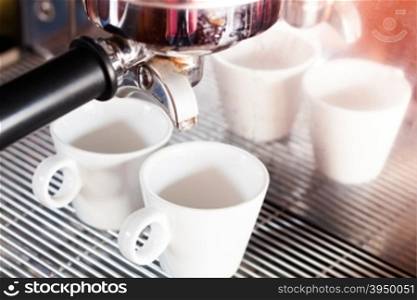 Prepares espresso in coffee shop with vintage filter style, stock photo