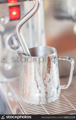 Prepares pitcher for steaming milk, stock photo