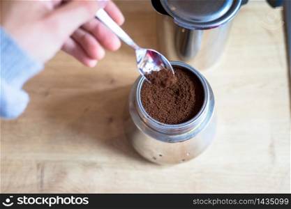 Preparing coffee: Close up of coffee powder in a vintage coffee cooker