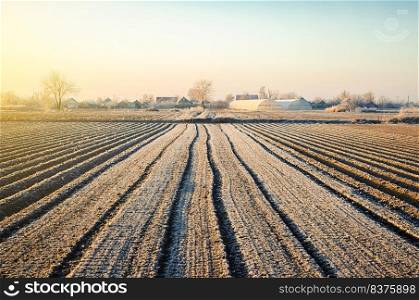 Preparing farm field for spring work and planting season. Choosing right time for sow fields plant seeds, protection from spring frosts. Agriculture agribusiness. Countryside and small households.