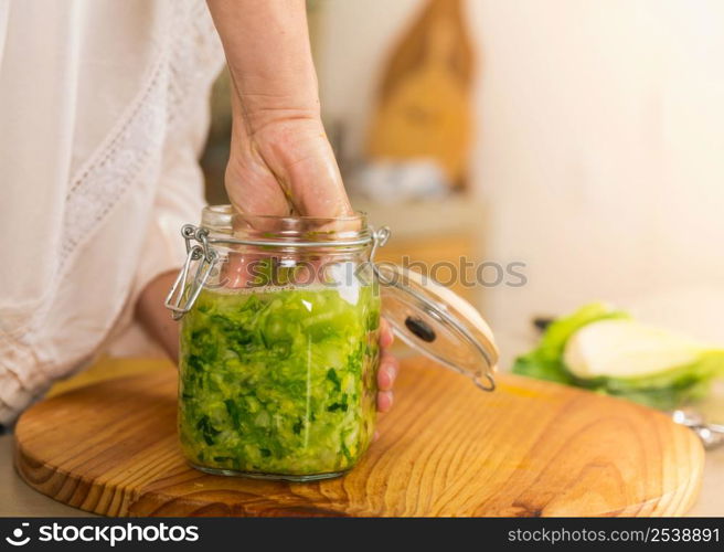 Preparing fermented preserved vegetables. Jars of cabbage kimchi and sauerkraut sour cabbage.