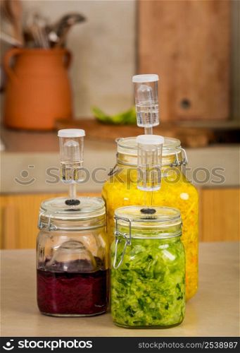 Preparing fermented preserved vegetables. Jars of cabbage kimchi and sauerkraut sour cabbage.
