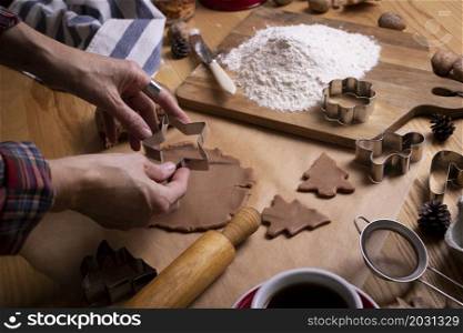 preparing for christmas. girl prepares gingerbread. hands in the frame