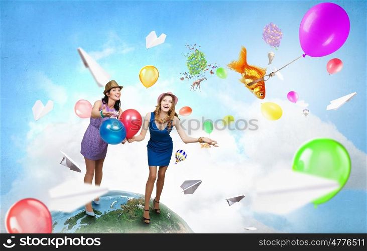 Preparing great party. Two young woman in casual with colorful balloons celebrating. Elements of this image are furnished by NASA