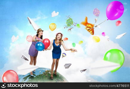 Preparing great party. Two young woman in casual with colorful balloons celebrating. Elements of this image are furnished by NASA