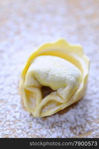 Preparing homemade tortellini on wooden table in the kitchen.&#xA;