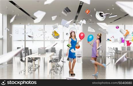 Preparing office party. Two young woman in casual celebrating in office