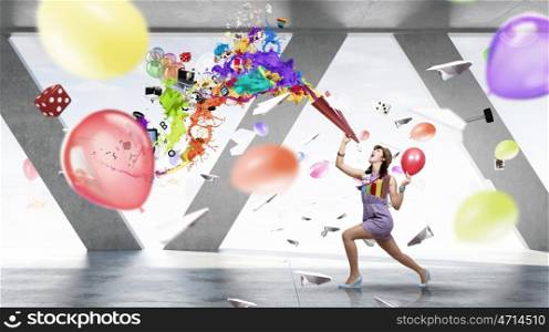 Preparing office party. Young woman in casual celebrating in office