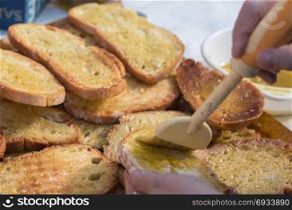 Preparing Slices of Grilled Bread with Olive Oil, Italian Snack