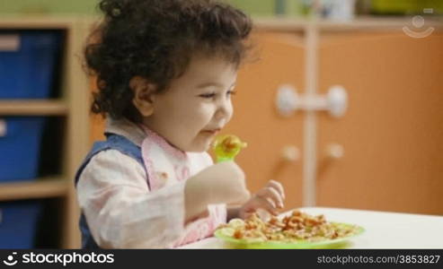 Preschool: baby girls having lunch