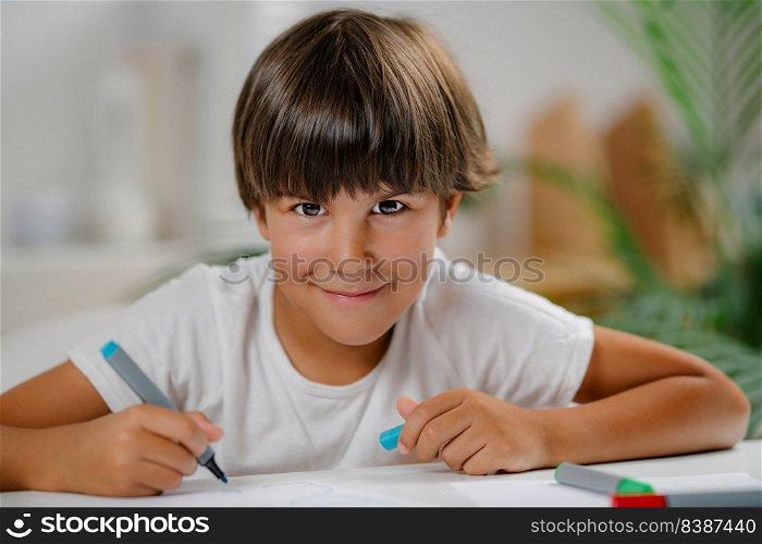 Preschooler boy sitting at the desk. Preschooler Boy at the desk