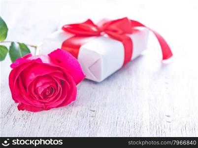 present and red rose on the white plate
