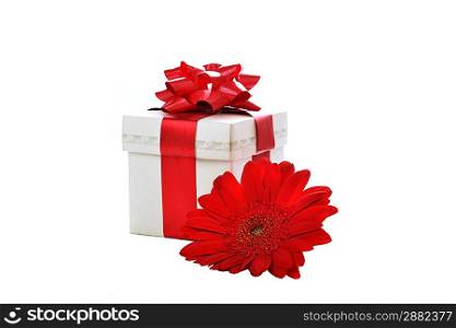 Present box with red gerbera on white silk