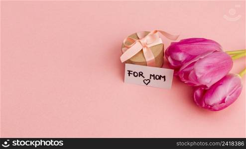 present box with ribbon near note flowers