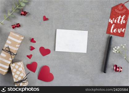 present boxes near paper hearts sheet pen tag