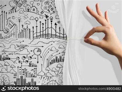 Presentation. Close up of hand opening the white curtain with business sketches behind