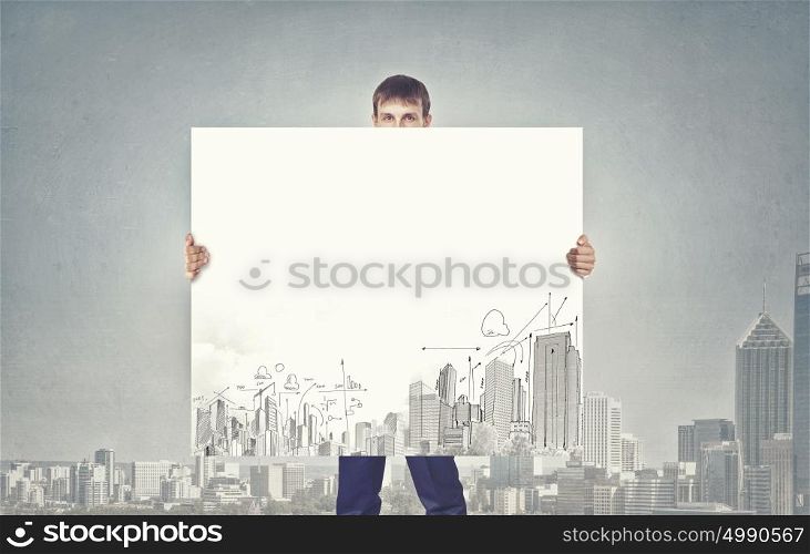 Presentation of development project. Businessman holding banner with urban construction concept