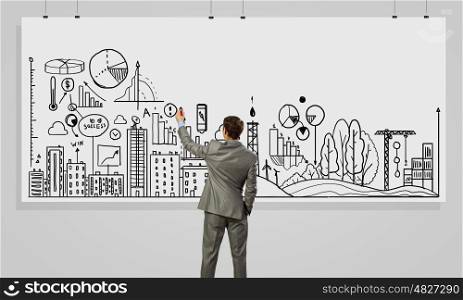 Presenting business strategy . Rear view of businessman drawing business plan on white banner