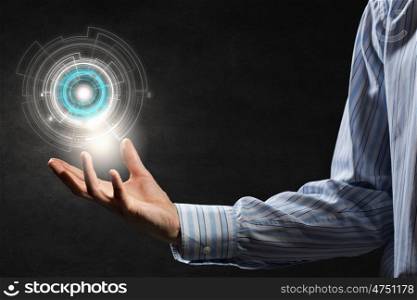 Presenting digital technologies. Close up of businessman holding media concept in palms