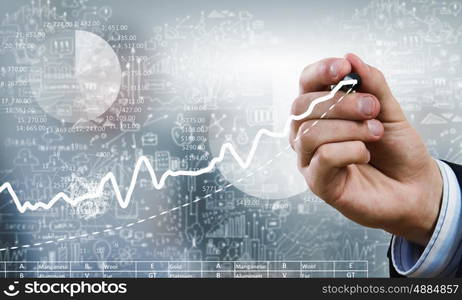 Presenting growth strategy. Close up of businessman drawing increasing graph with marker on media screen