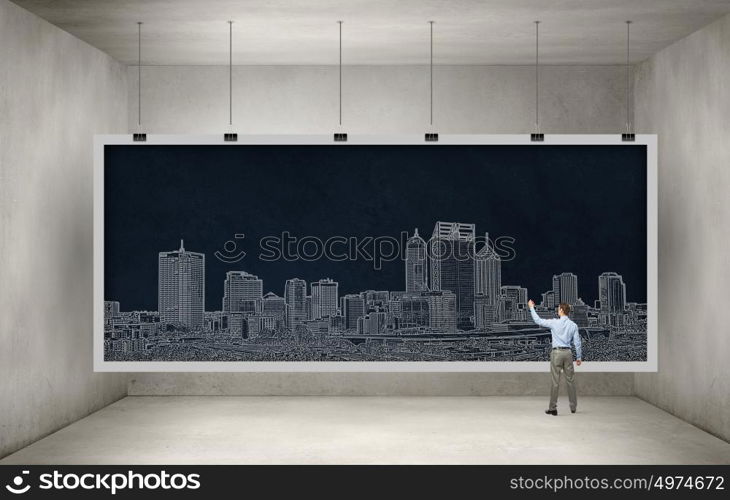 Presenting ideas. Rear view of businessman drawing business plan on banner