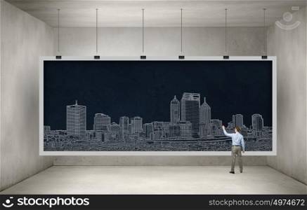 Presenting ideas. Rear view of businessman drawing business plan on banner