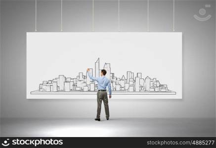 Presenting ideas. Rear view of businessman drawing business plan on white banner