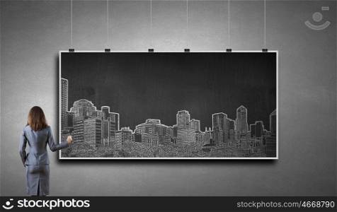 Presenting ideas. Rear view of businesswoman drawing business plan on banner