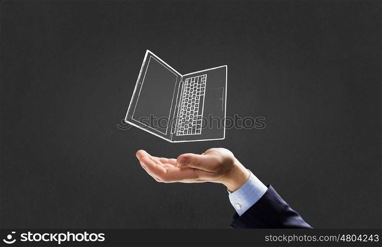 Presenting laptop. Human hand holding in palm laptop symbol