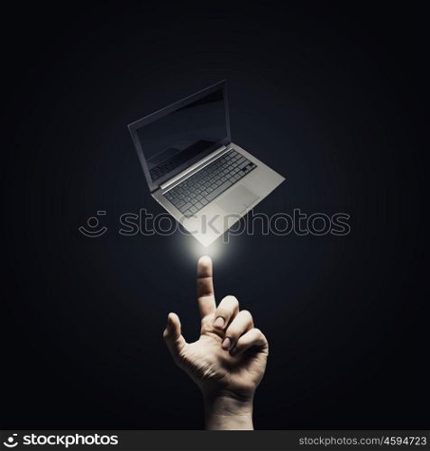 Presenting laptop. Male hand pointing with finger at laptop symbol