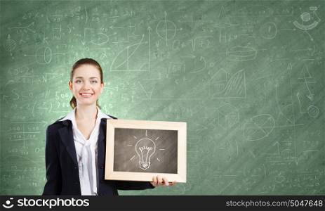 Presenting new idea. Young woman holding wooden frame with bulb